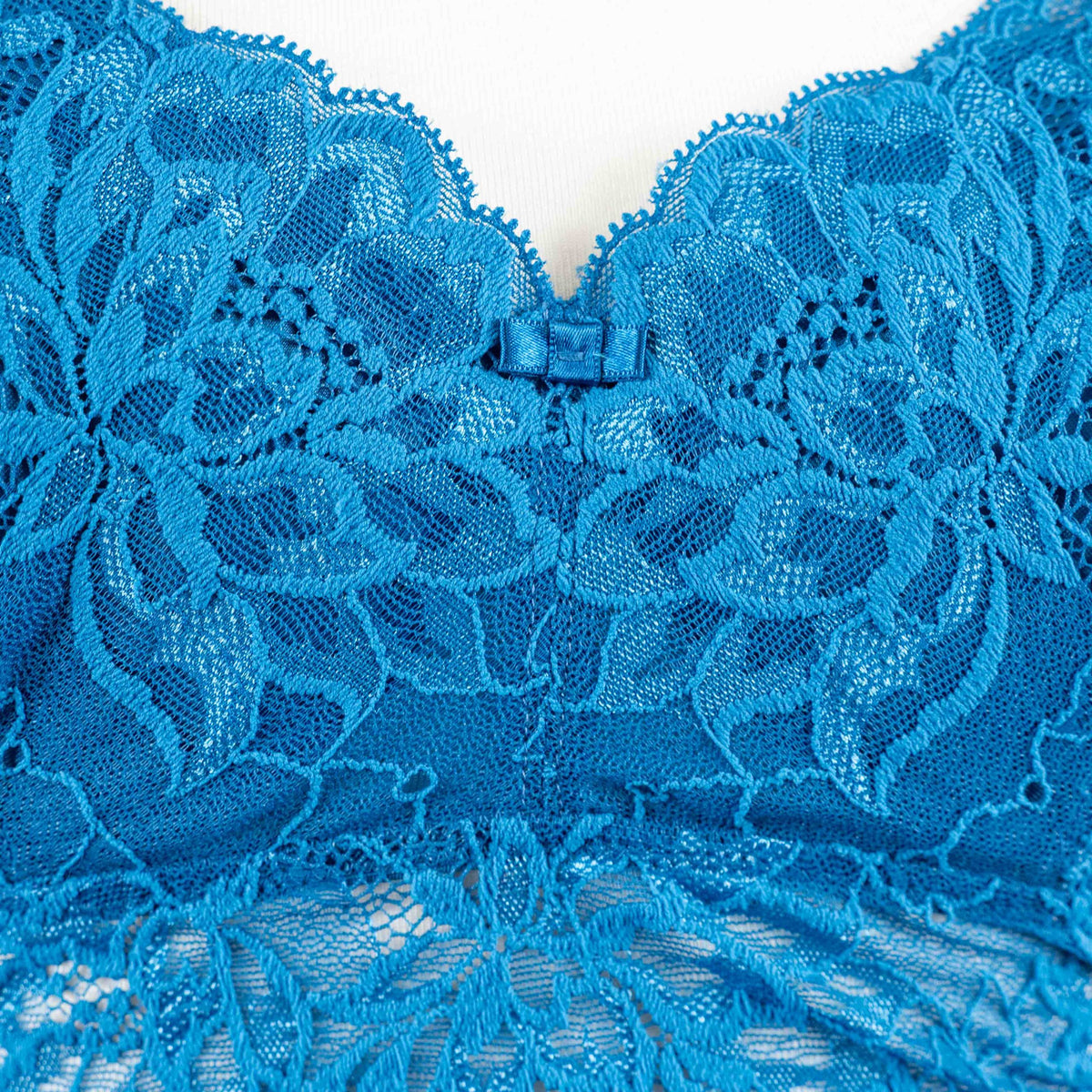 Triumph blue lace underwired bra with floral patterns and small bow detail.