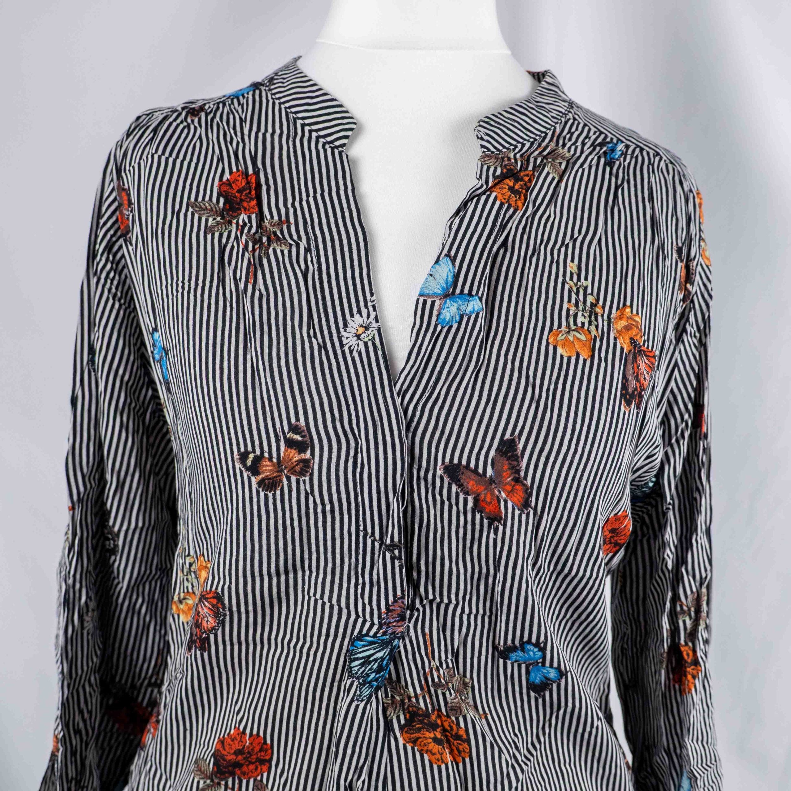 Dorothy Perkins black and white striped blouse with colourful butterfly print and tie cuffs.