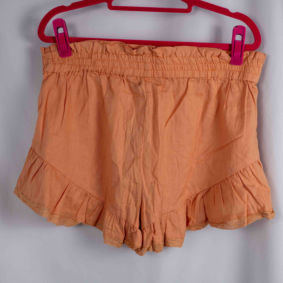 Boohoo orange linen ruffle shorts with lace trim and elasticated waistband.