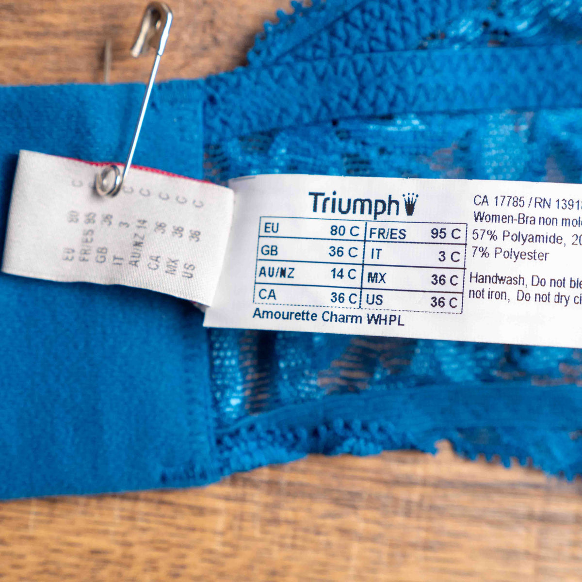 Triumph blue lace underwired bra with floral patterns and small bow detail.
