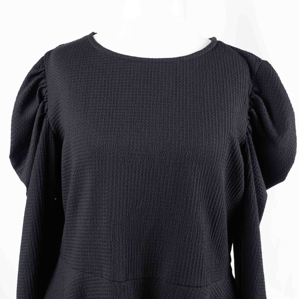 Dorothy Perkins black blouse with peplum hem and textured puff sleeves.