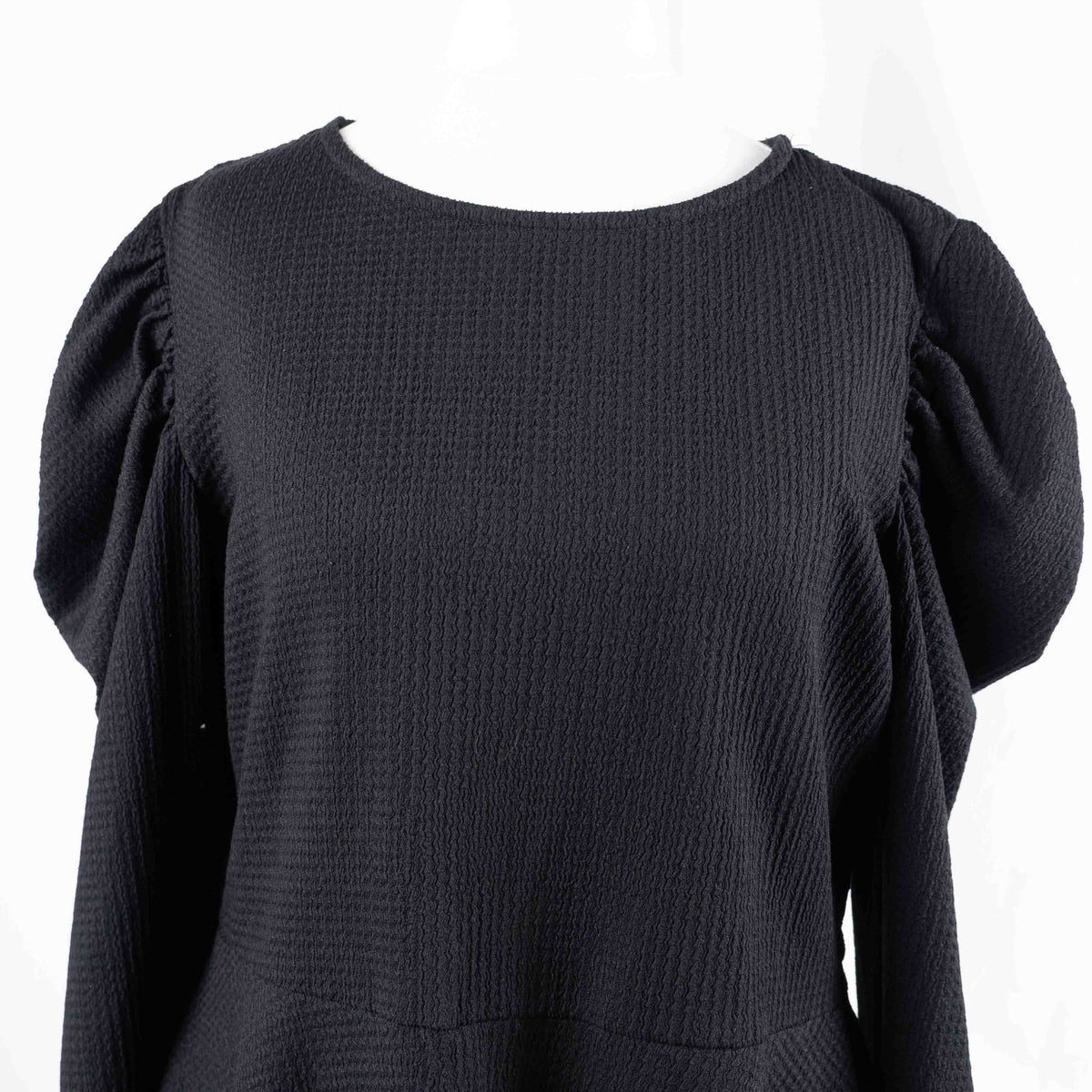 Dorothy Perkins black blouse with peplum hem and textured puff sleeves.