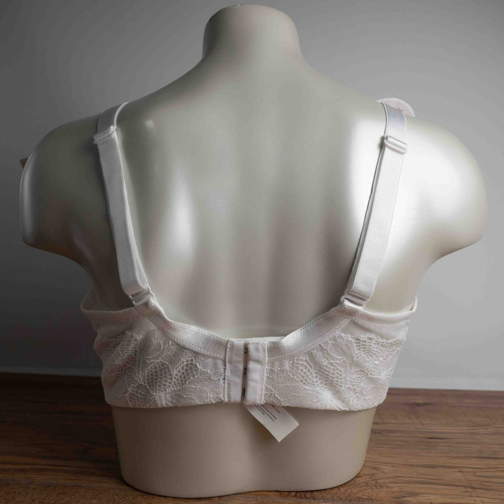 Triumph white lace soft cup bra with adjustable straps and lace-back detail.