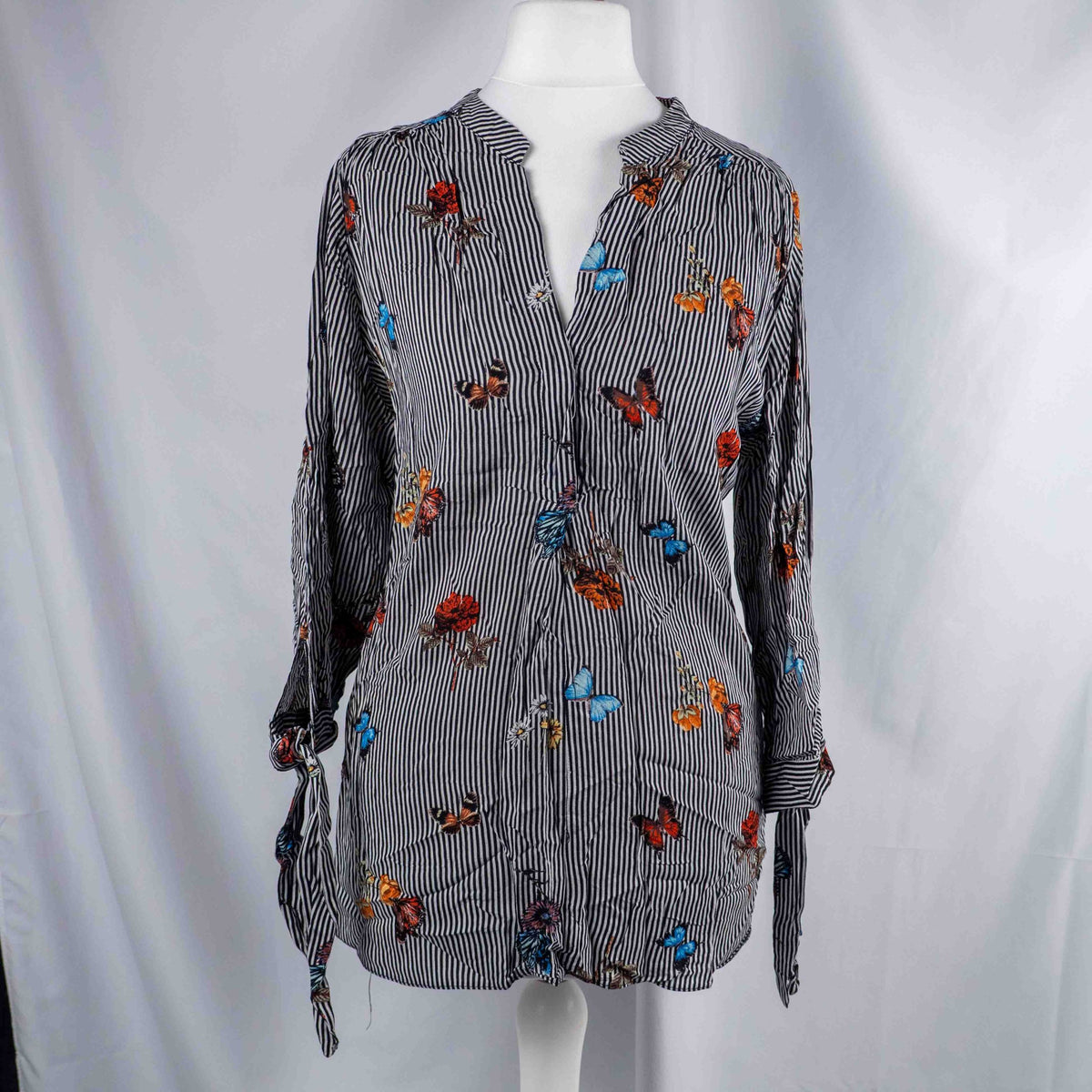 Dorothy Perkins black and white striped blouse with colourful butterfly print and tie cuffs.