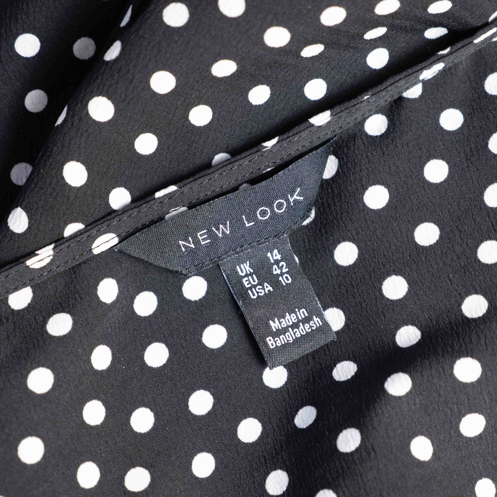 New Look black and white polka dot tunic blouse with V-neck and ruffled sleeves.