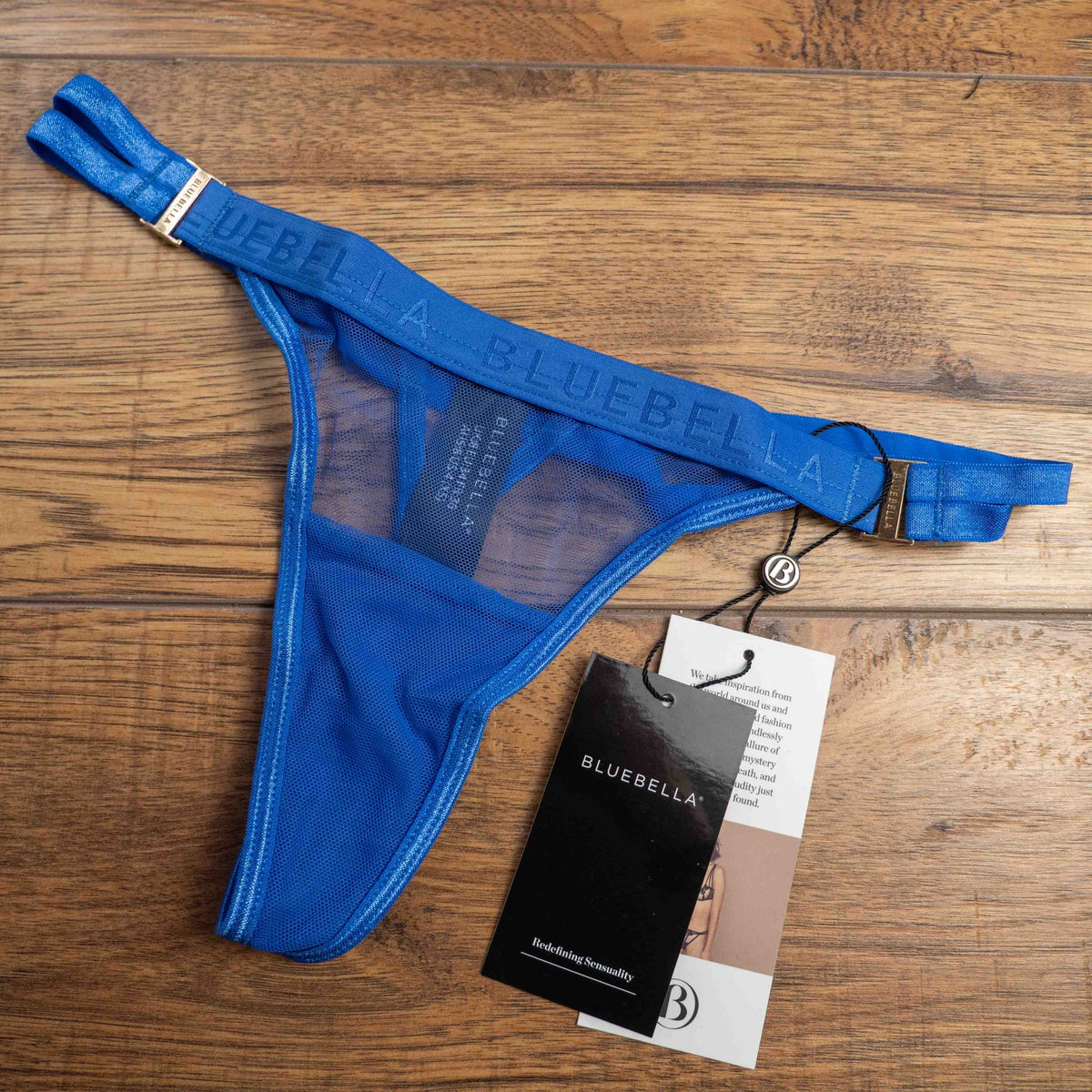 Bluebella blue lace thong with mesh detailing and elastic waistband featuring logo.
