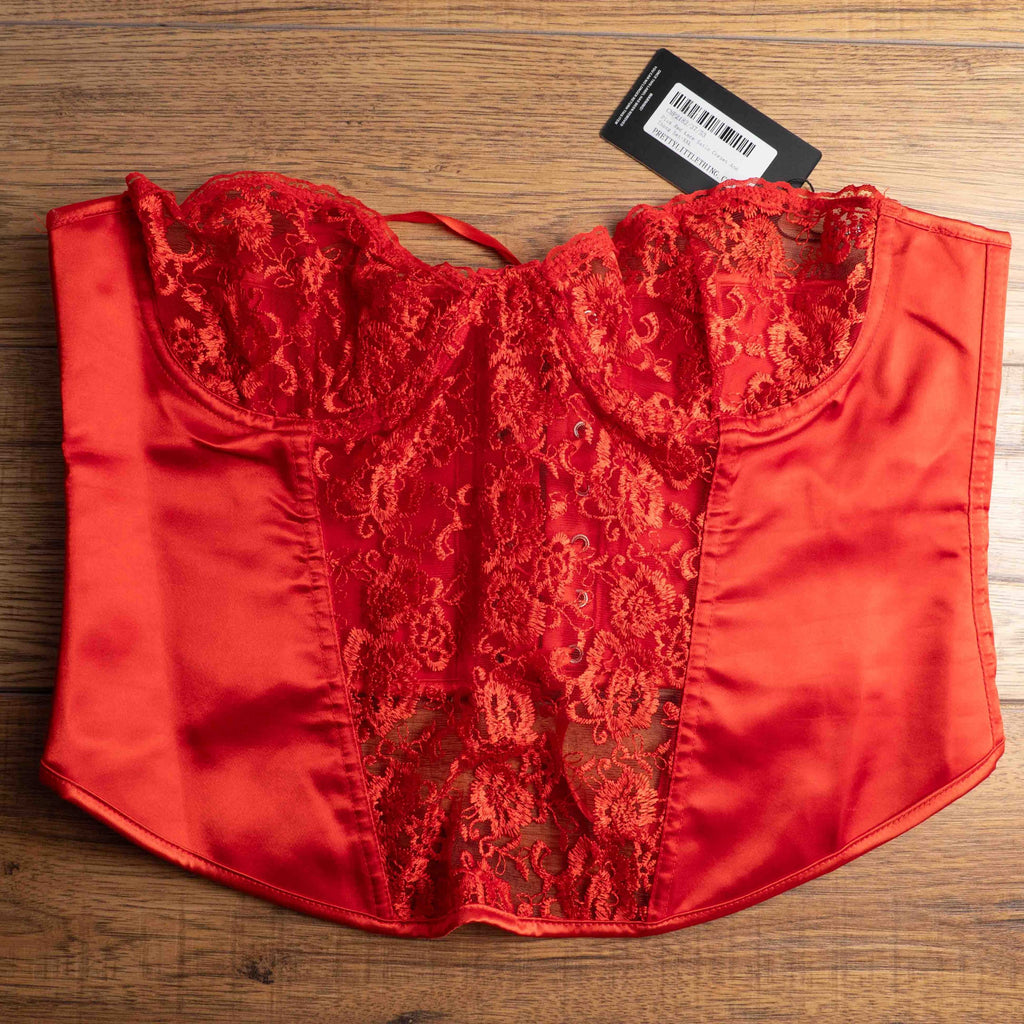 Red corset top with sheer floral lace bodice and satin sides, adjustable lace-up back.