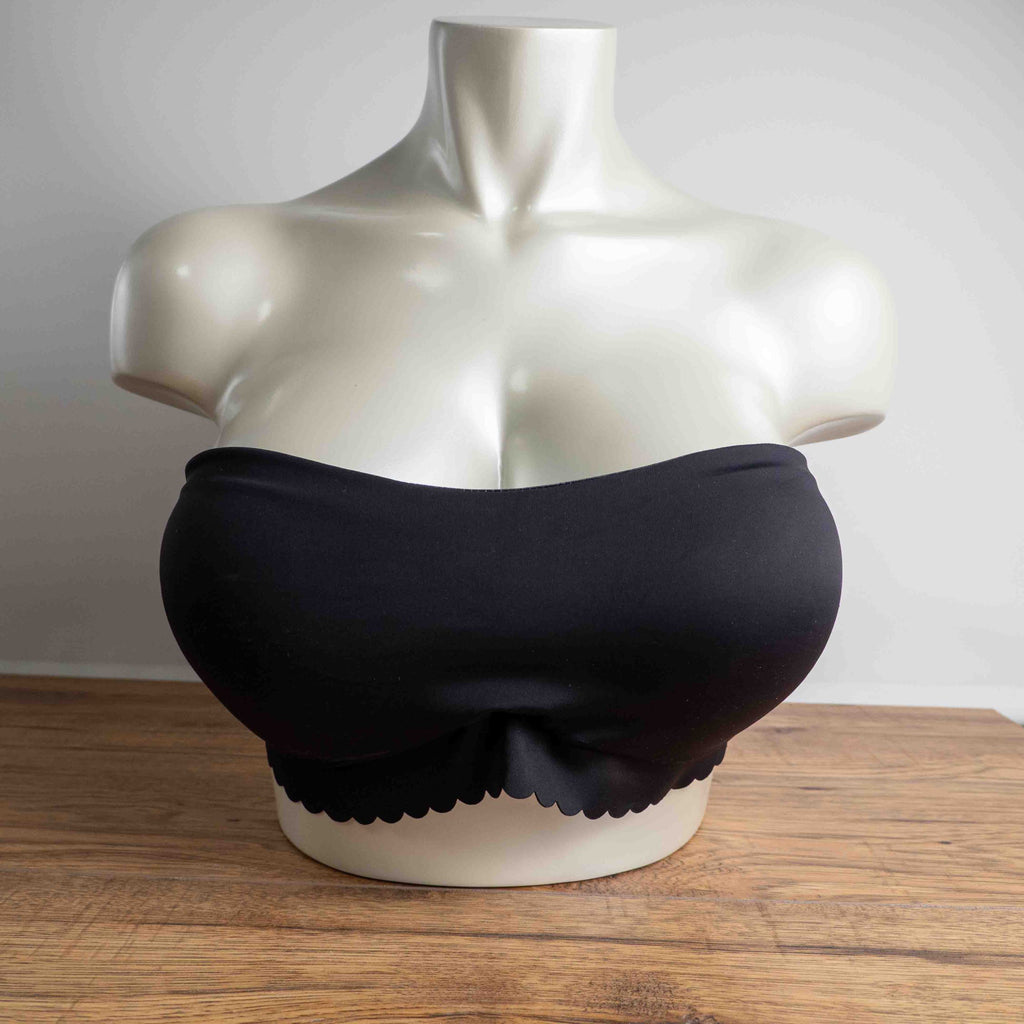 Next black strapless bandeau bra with scalloped hem and multiple hook back closure.