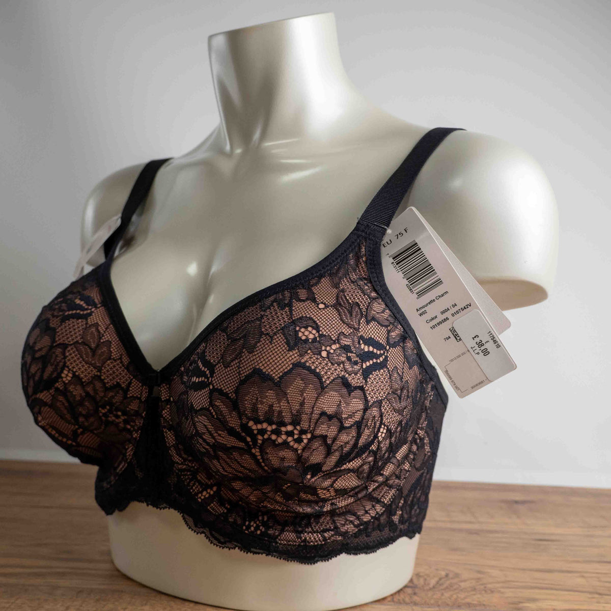 Triumph black lace bra with elegant overlay, underwired, adjustable straps, brand new with tags.
