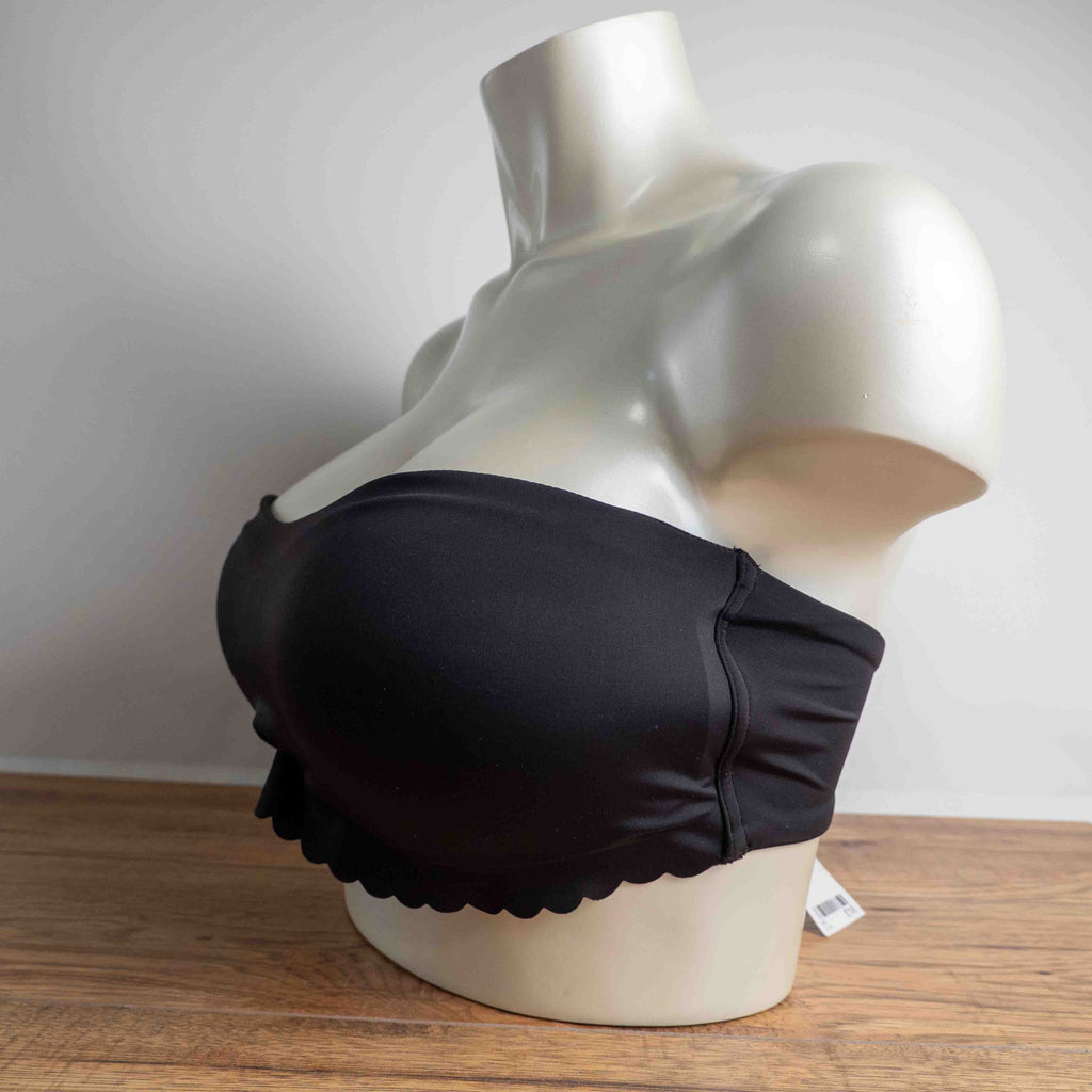 Next black strapless bandeau bra with scalloped hem and multiple hook back closure.
