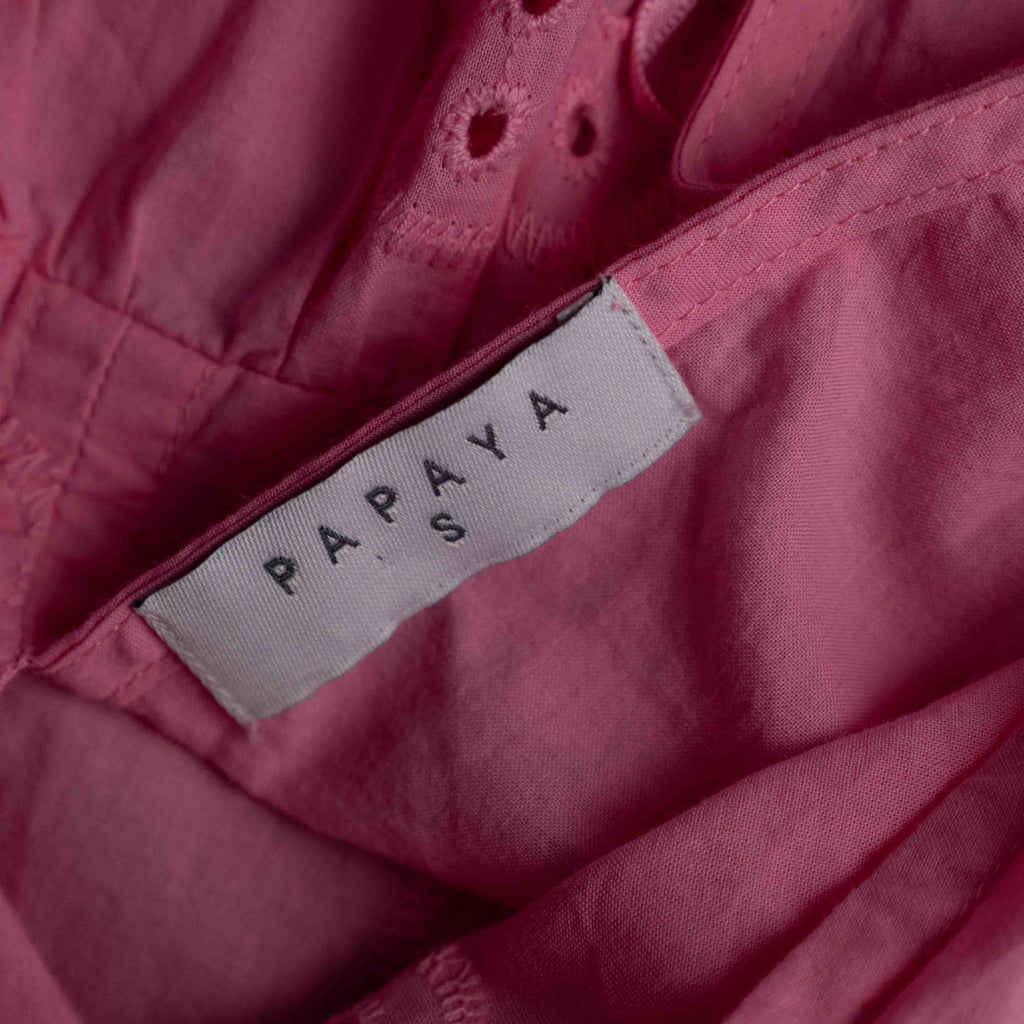 Papaya pink casual dress with embroidered floral patterns and flutter sleeves.