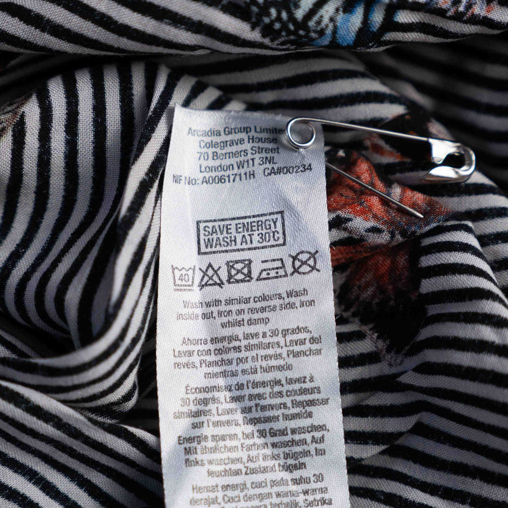 Dorothy Perkins black and white striped blouse with colourful butterfly print and tie cuffs.