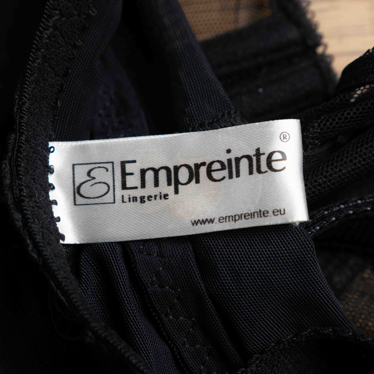 Empreinte black shapewear bodysuit with lace detailing, underwired cups, adjustable straps.