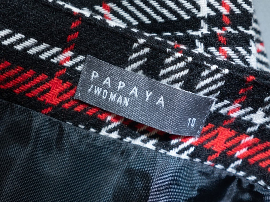 Papaya tan mini skirt black, red, and white checked pattern with zip and button closure.