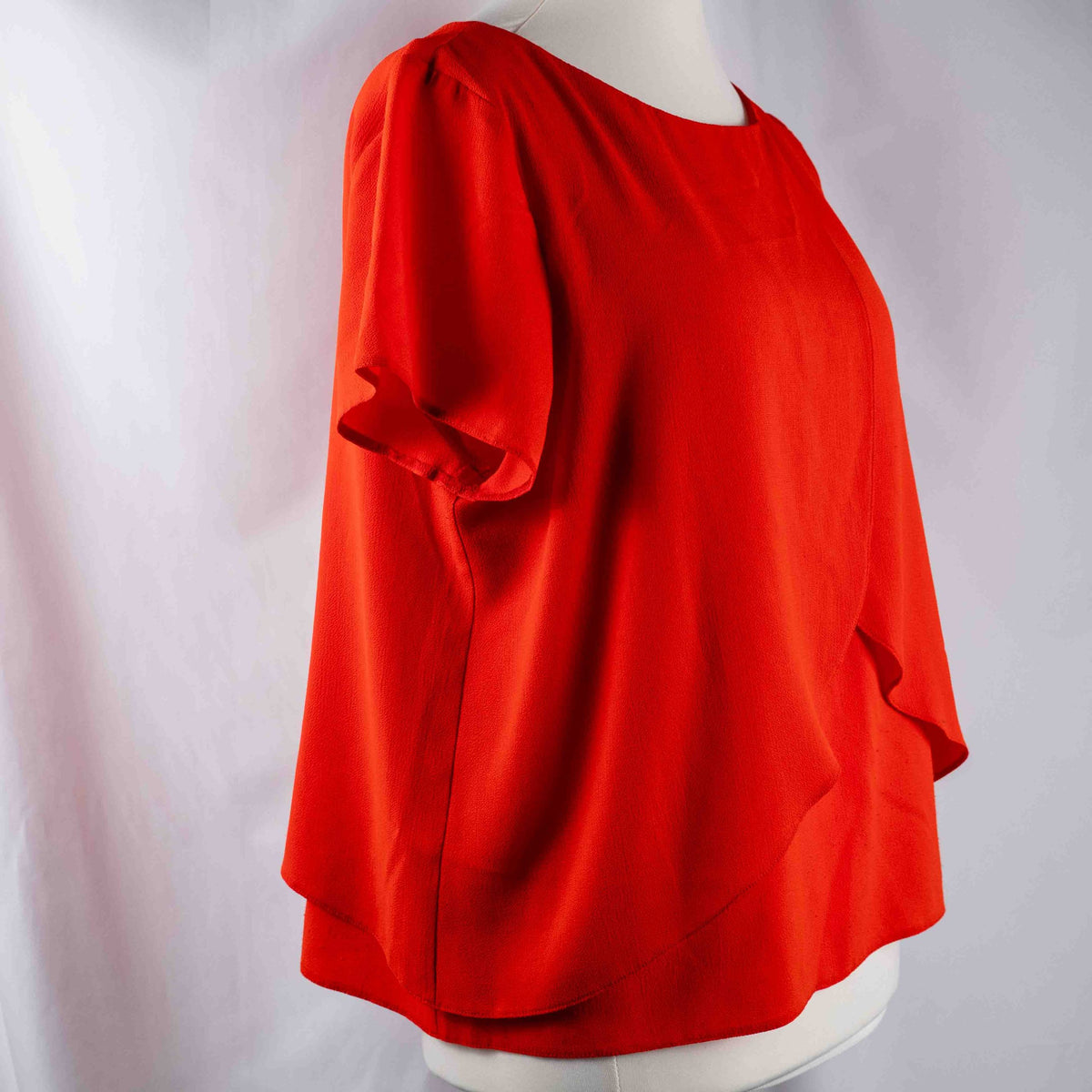 M&Co red layered blouse with short sleeves, made of polyester and elastane.
