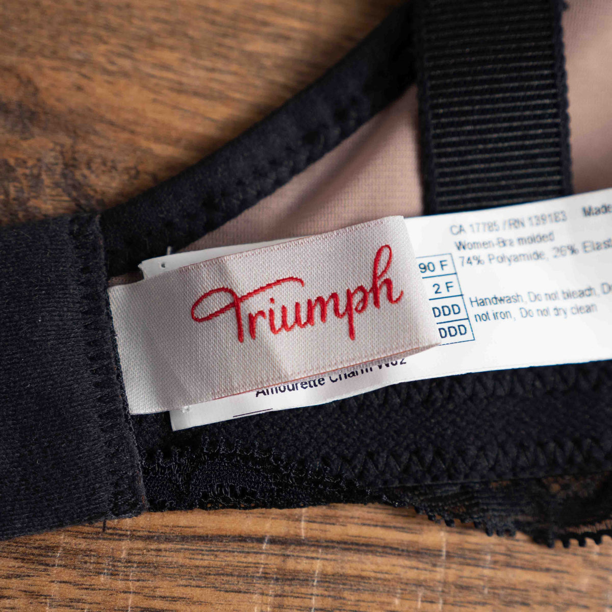Triumph black lace bra with elegant overlay, underwired, adjustable straps, brand new with tags.