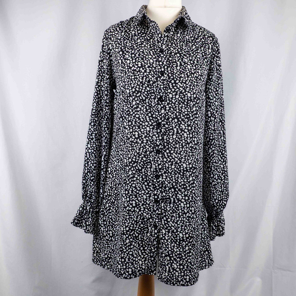 Missguided black and white spot print shirt with button-down front and flared cuffs.