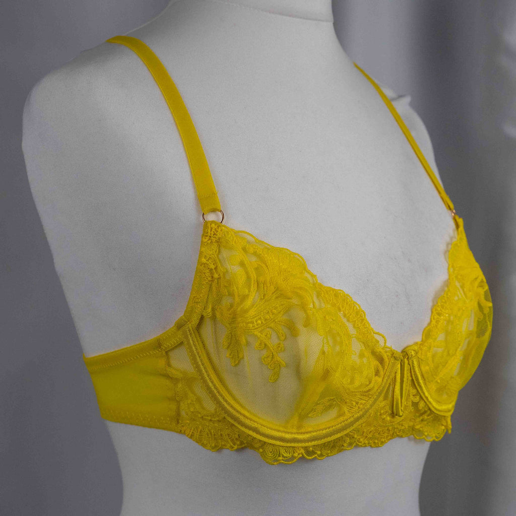 Bluebella yellow sheer lace bra with floral pattern and adjustable straps.