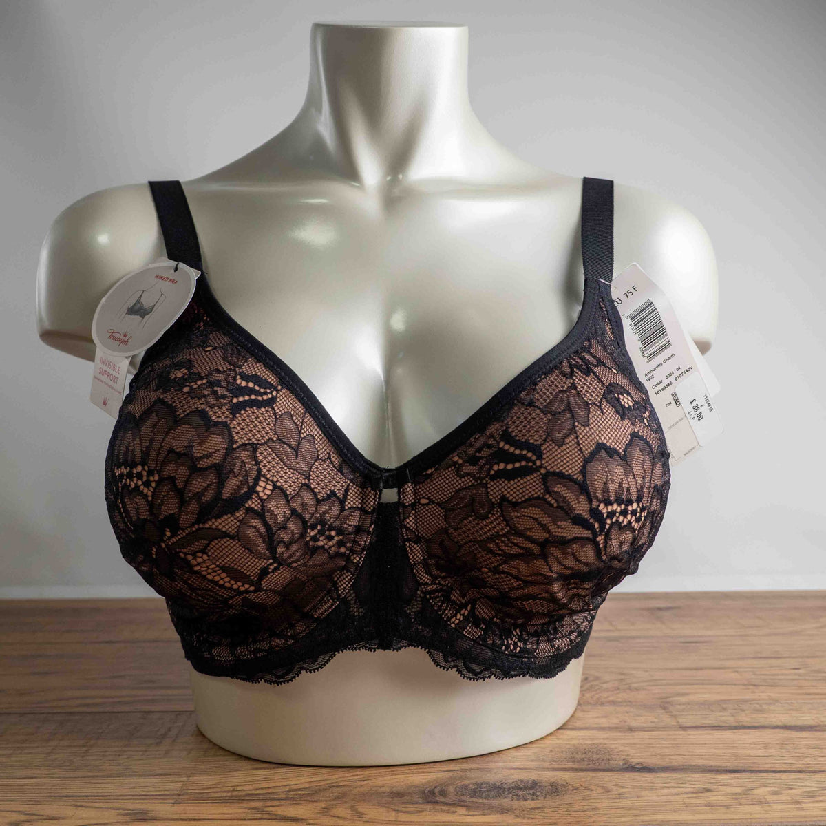 Triumph black lace bra with elegant overlay, underwired, adjustable straps, brand new with tags.