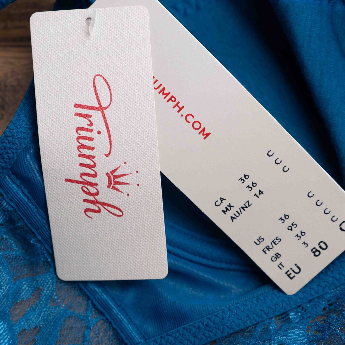 Triumph blue lace underwired bra with floral patterns and small bow detail.