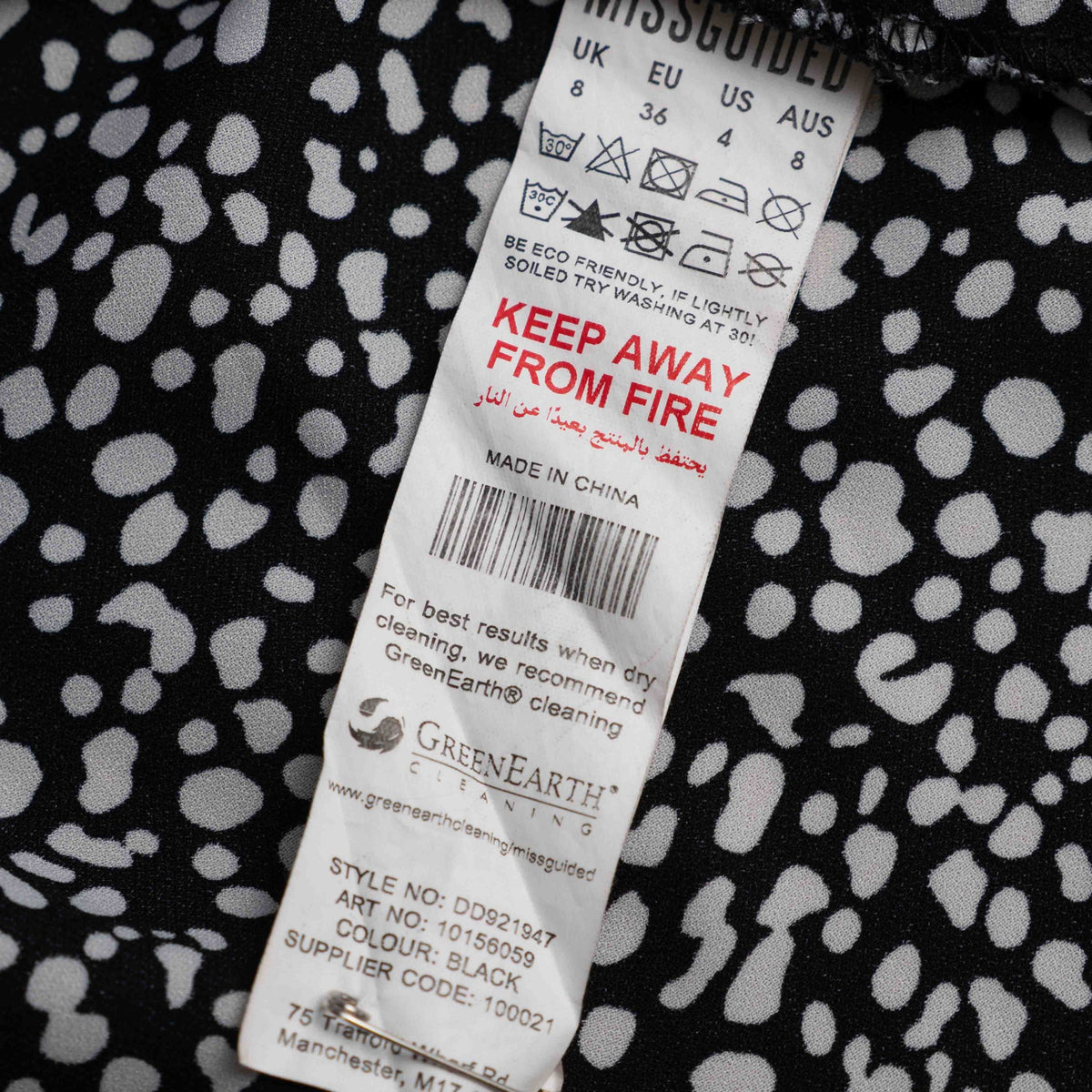 Missguided black and white spot print shirt with button-down front and flared cuffs.