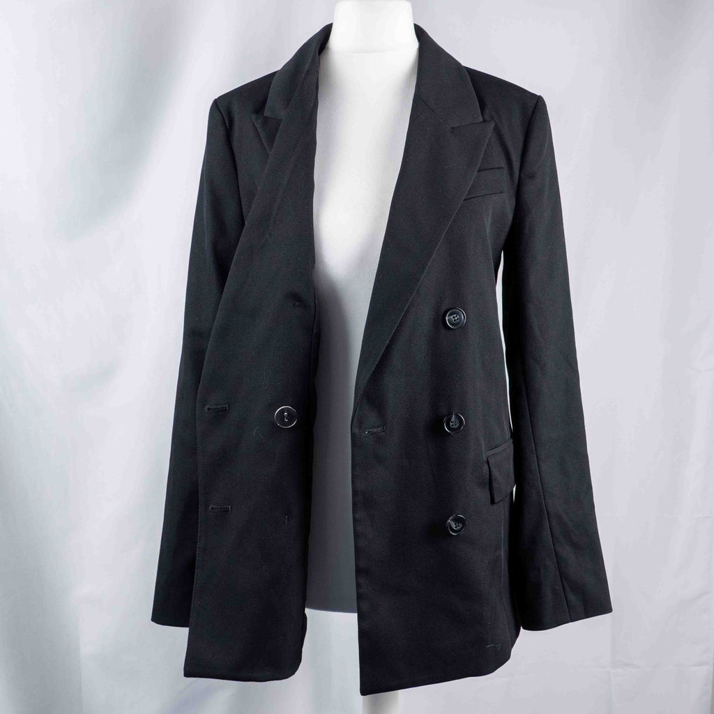 H&M black double-breasted blazer with structured lapel and six front buttons.