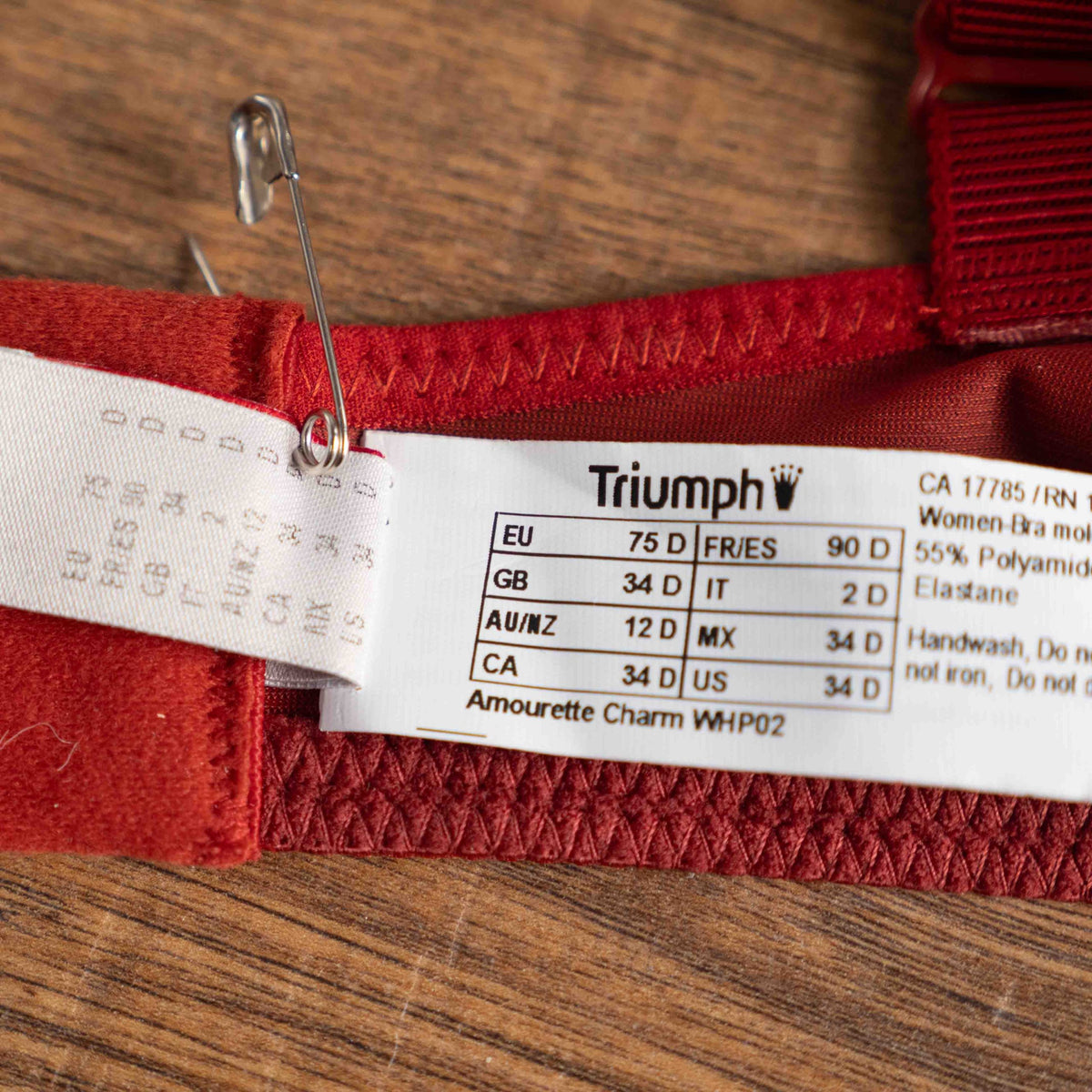 Triumph red lace bra with padded cups and adjustable straps, new with tags.