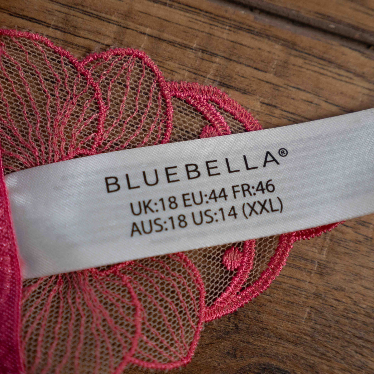 Bluebella pink lingerie thong with sheer floral lace detailing and adjustable straps.