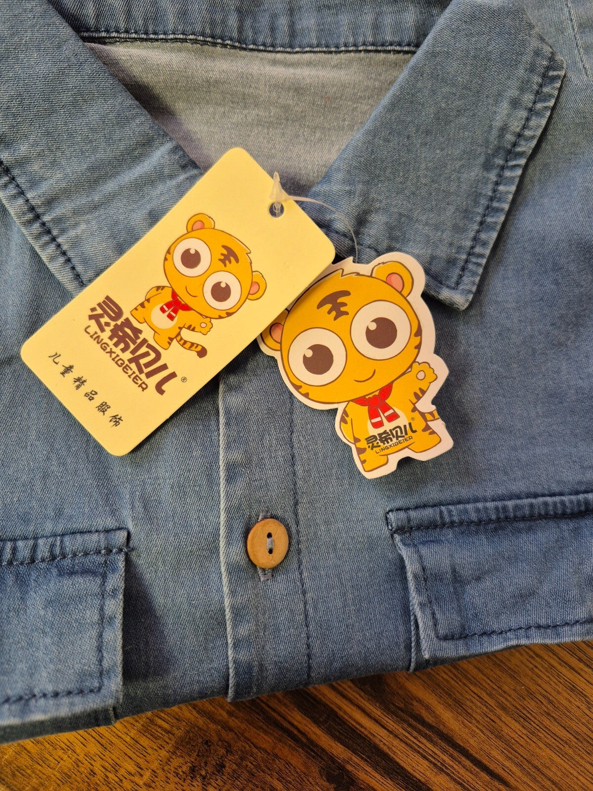 Lingxibeier blue denim jumpsuit with giraffe pattern, long sleeves, and front pockets.