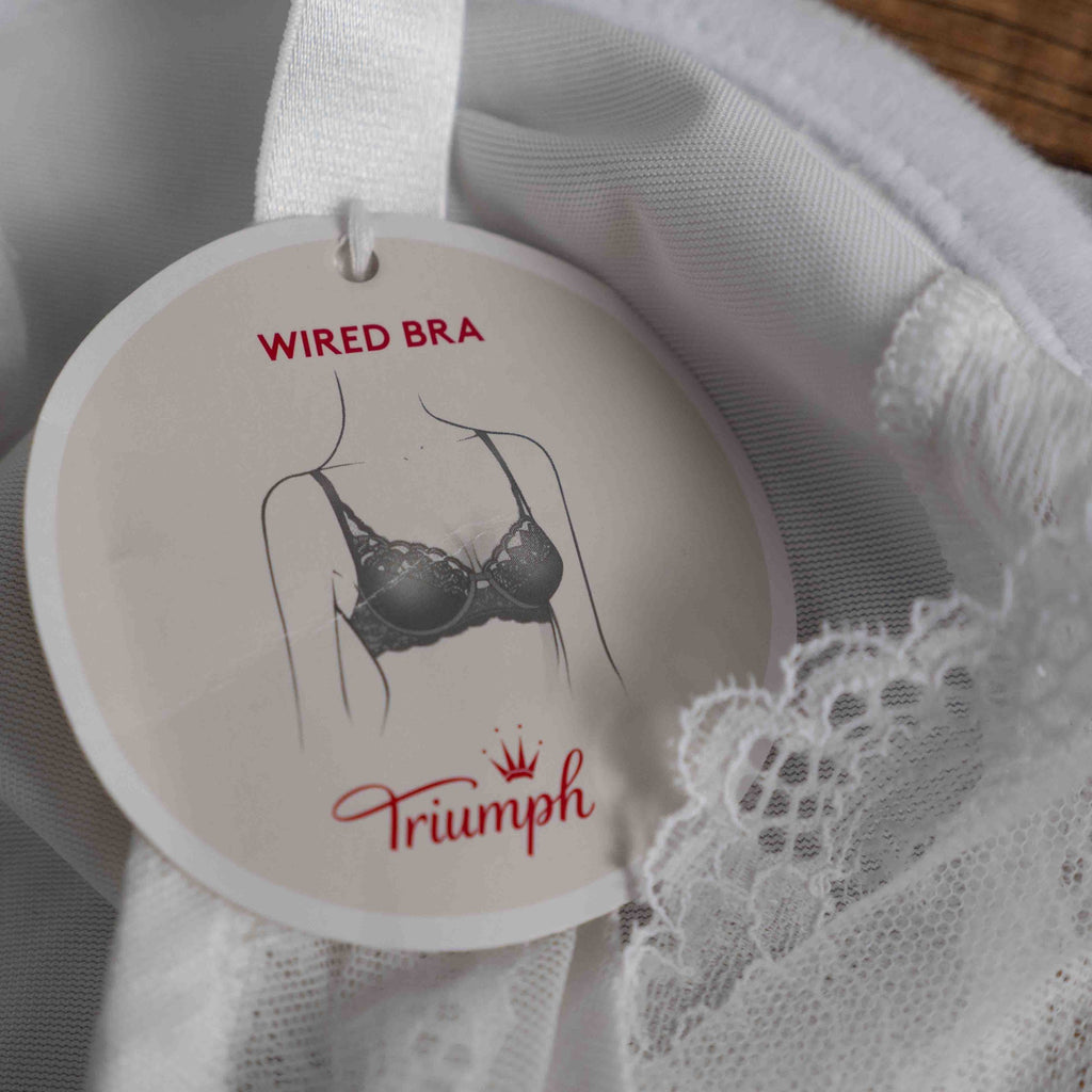 Triumph white lace soft cup bra with adjustable straps and lace-back detail.