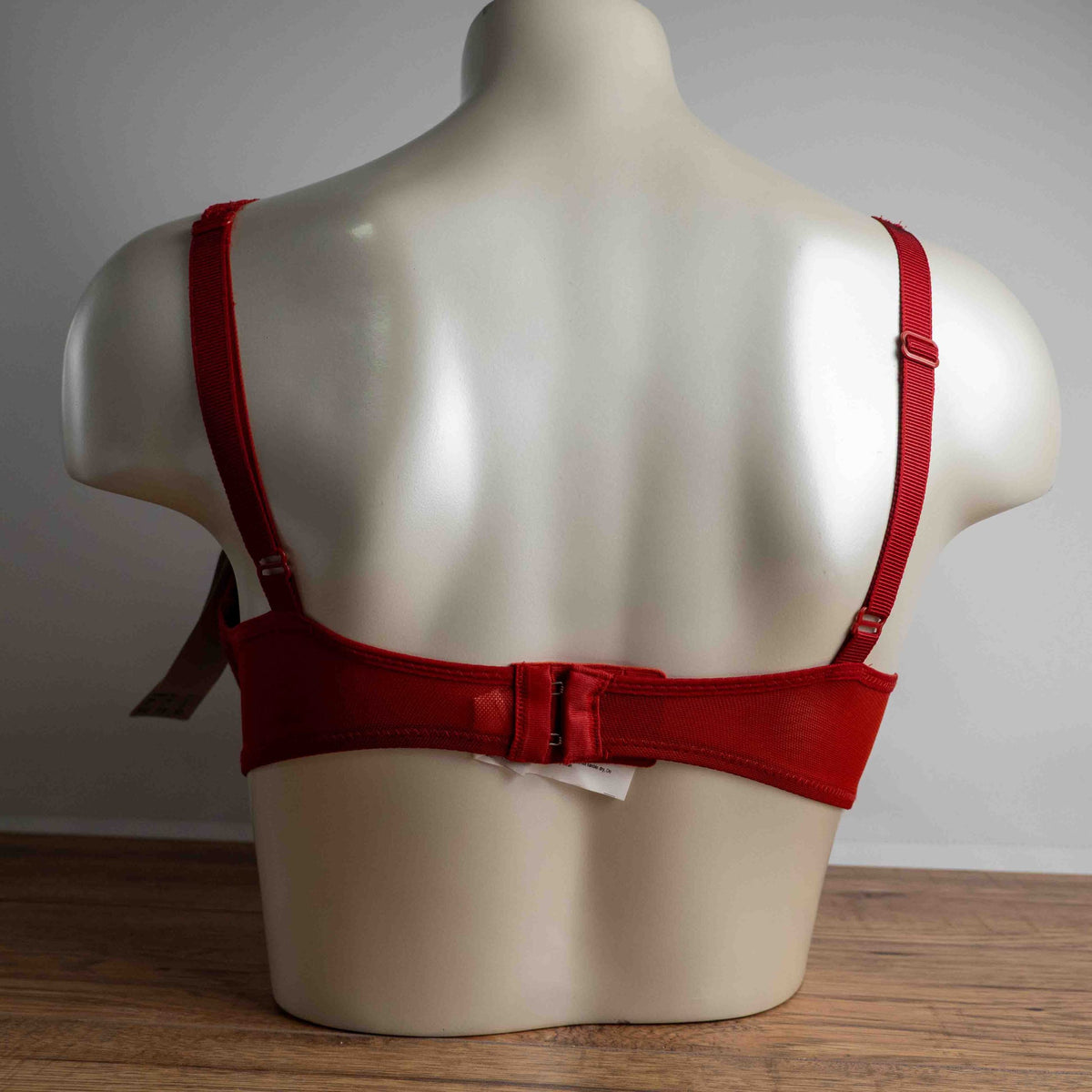 Triumph red lace bra with padded cups and adjustable straps, new with tags.