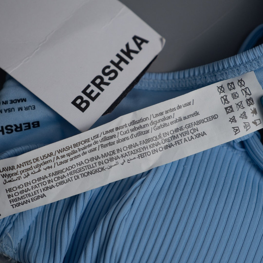 Bershka blue bikini top with line pattern, underwired, padded, and back buckle closure.