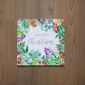 Christmas card with festive foliage and pinecones on a white background