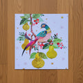 Colorful bird illustration on a blue background with pears and leaves